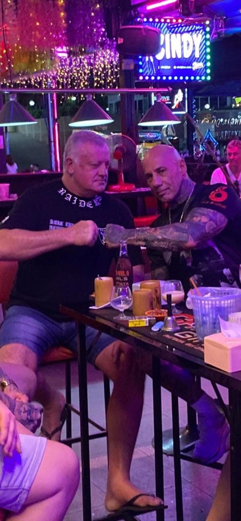 Rick sharing a fist bump with a friend on a night out